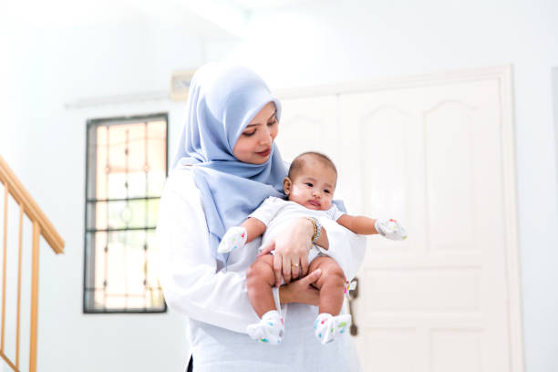 istock Young beautiful mother embracing baby 1163266960