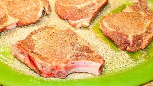 Pork Chops Raw and Seasoned stock photo