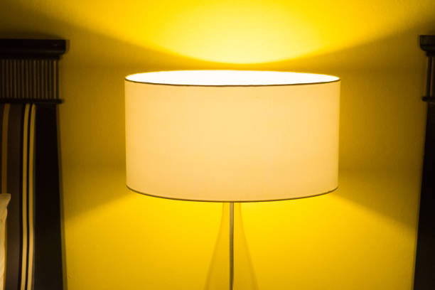 istock yellow lamp with warm yellow light in bedroom 1163276211