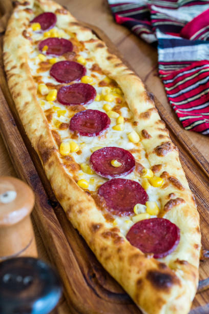 istock Traditional Turkish Pide at Kebab Restaurant on Wooden Table. 1163277835