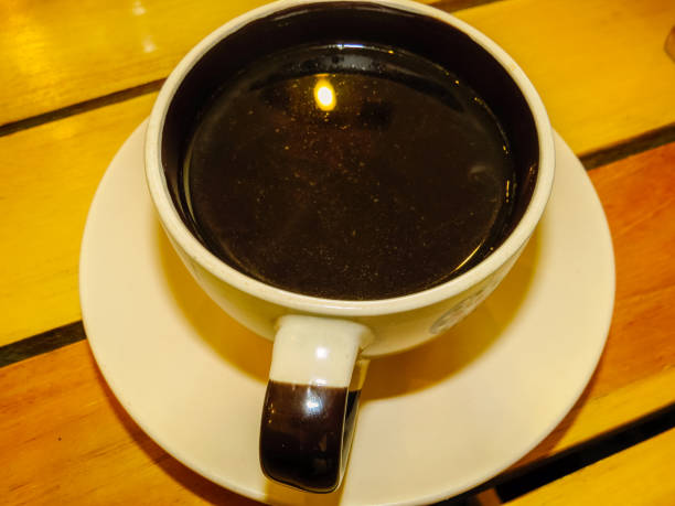 istock Cup of coffee with plate over wood table 1163278008