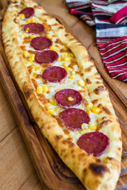 istock Traditional Turkish Pide at Kebab Restaurant on Wooden Table. 1163282009