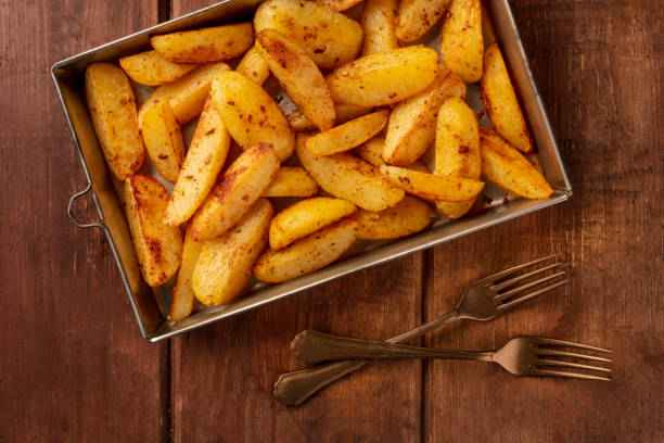 istock Potato wedges, oven baked, shot from above on a baking sheet 1163282975