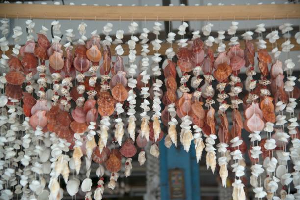 istock Sea shell mobile hanging decoration in the shop. 1163283845