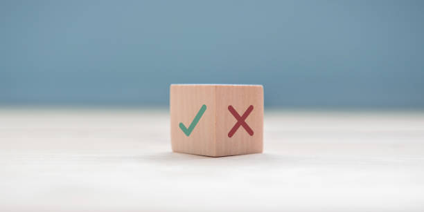 True and false symbols accept rejected for evaluation, Yes or No on wood blogs on blue background.