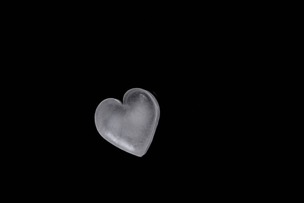 istock icy cold heart shaped ice cube on a black background 1163286074