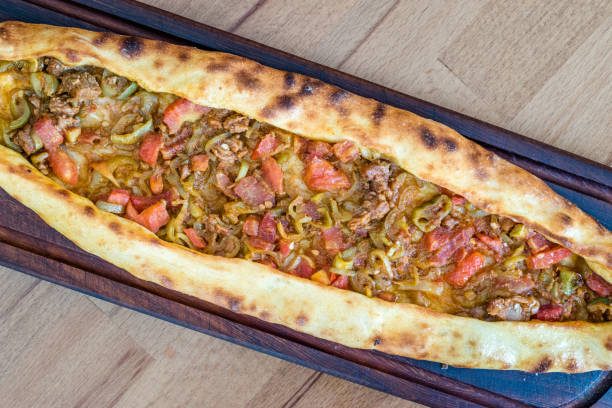 istock Traditional Turkish Pide at Kebab Restaurant on Wooden Table. 1163289359