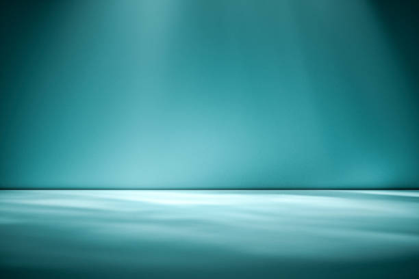 istock Beams of sunlight on a blue green background 1163292790