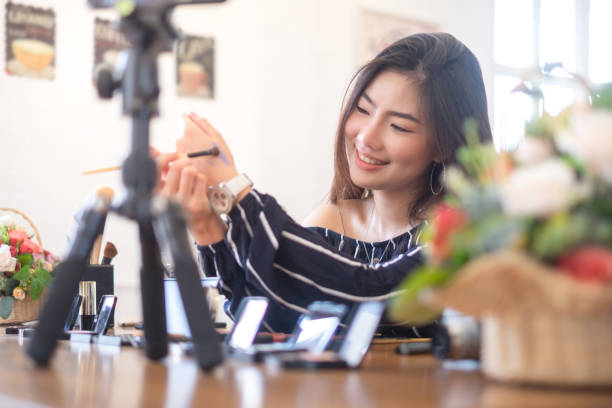 istock Happy girl blogger at cafe talking about makeup and beauty and recording video tutorial for internet, blogger concept