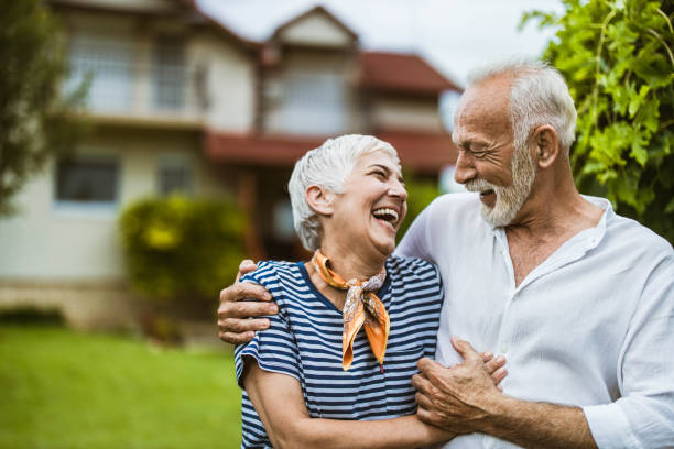 istock Embraced senior couple talking about something funny in the backyard. 1163301539