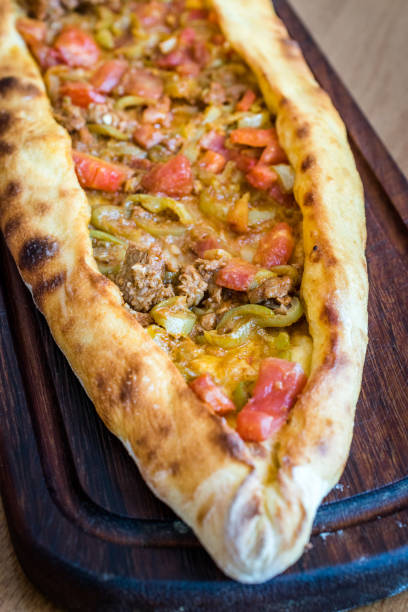 istock Traditional Turkish Pide at Kebab Restaurant on Wooden Table. 1163301897