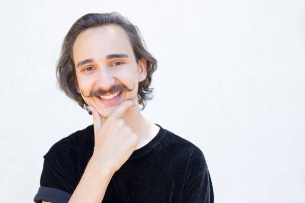 istock Happy young man with handlebar mustache looking at camera. 1163302569
