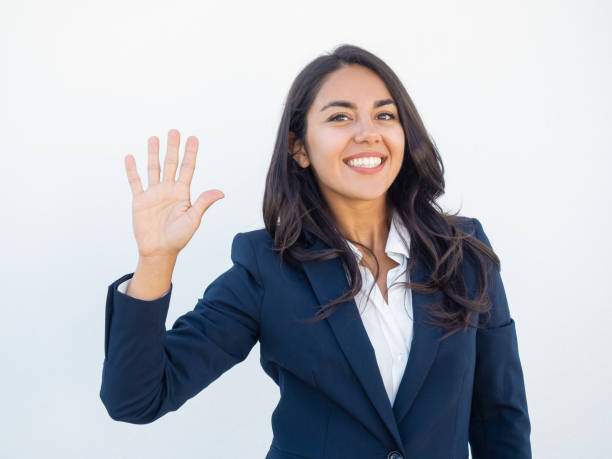 Positive friendly businesswoman making greeting gesture