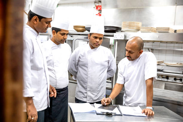 istock Chefs cooking in a professional kitchen of a gourmet restaurant 1163305773