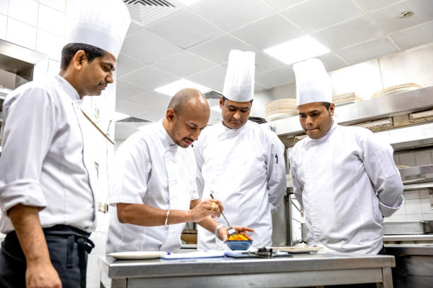 istock Chefs cooking in a professional kitchen of a gourmet restaurant 1163305813