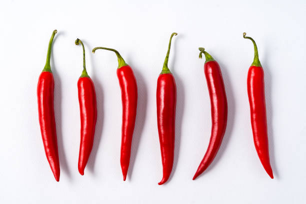 istock Red ripe chili spicy peppers over white background. 1163306485