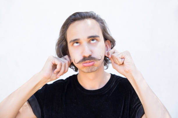 istock Ridiculous young man with handlebar mustache having fun. 1163307566