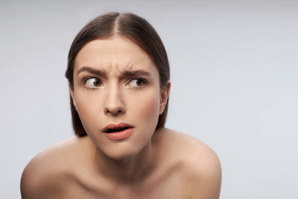 istock Young lady with beautiful brown eyes raising eyebrows 1163308810