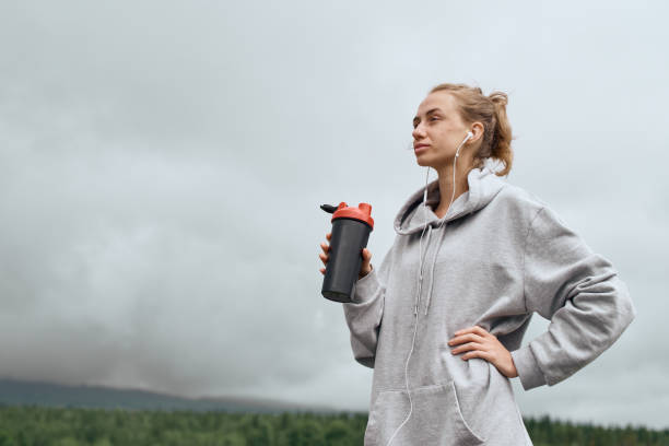 istock Female with water bottle outdoor 1163308911