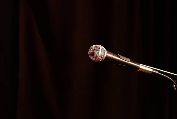 istock old acoustic microphone of a round form factor on a dark background 1163309111