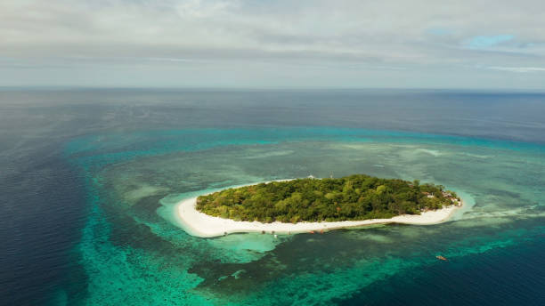 istock Tropical island with sandy beach. Mantigue Island, Philippines 1163311320