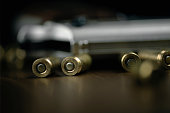 Gun and bullets on wood background