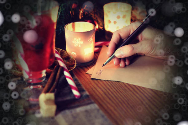 istock christmas hand writing story 1163312523