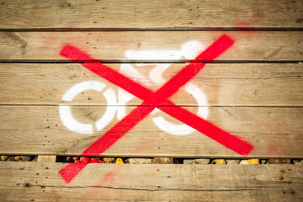 Red Cross over a cycling symbol on wooden planks