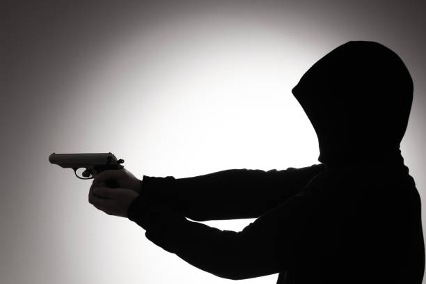 istock Silhouette of thug in hoodie 1163312836