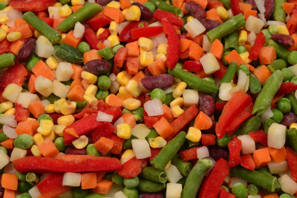 istock Sliced vegetables, corn, beans, peas, carrots, sweet peppers background. 1163316402