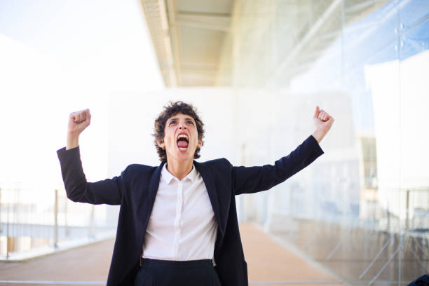 istock Successful businesswoman triumphing and looking up 1163317361