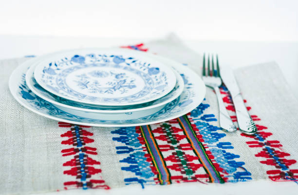 istock Table setting for dinner: plate, a fork, a knife on a woven cloth napkin with an embroidered pattern,  traditional handmade in Ukraine 1163320596