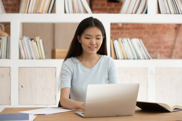 istock Asian female student work on laptop studying for exam 1163323418