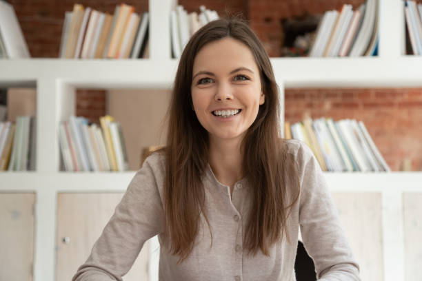 istock Smiling girl look at camera shooting online training course 1163323423