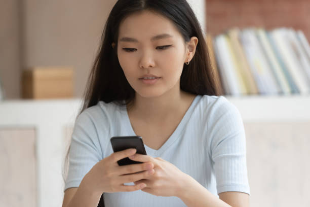 istock Asian girl hold using smartphone texting or messaging 1163323424