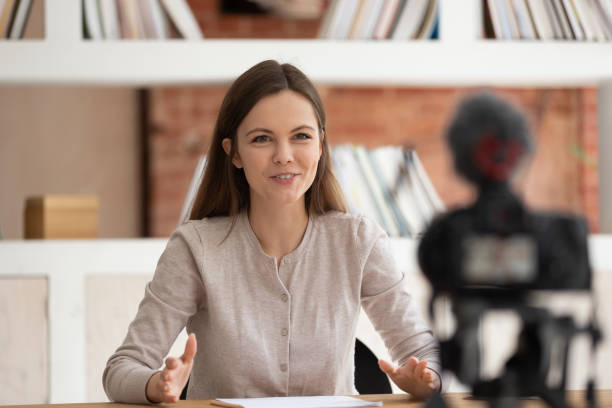 istock Smiling girl vlogger record talk video on professional camera 1163323429