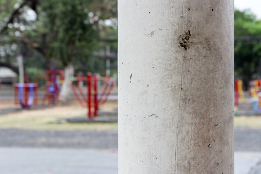 Close up of ordinary pole in the park, Thailand. It has small crack on surface.