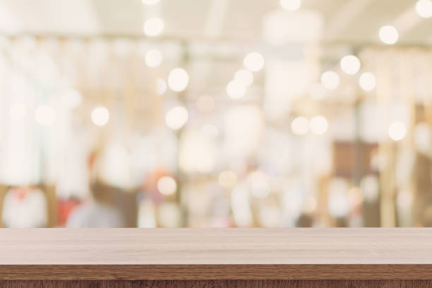 istock Empty wooden table with blurred abstract people on cafe on restaurant background. 1163326292