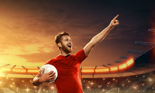 istock Soccer player holds a ball and celebrates goal 1163326302