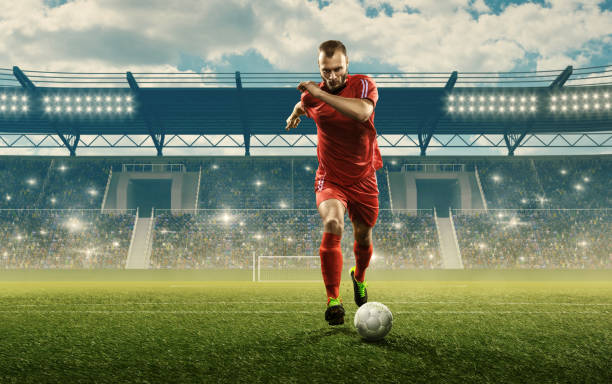 istock Soccer player dribbles a ball on a stadium 1163326322