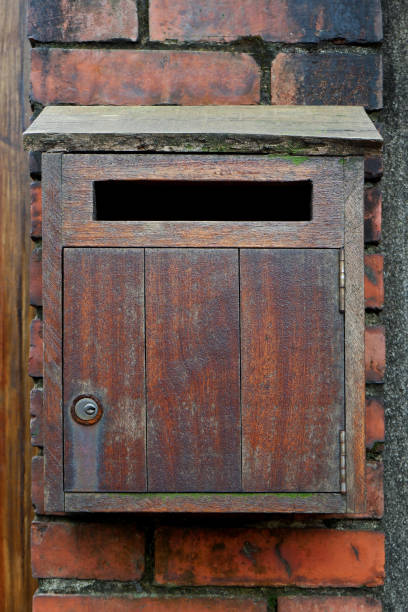 istock Vintage Wooden Mailbox on the Brick Wall 1163328492