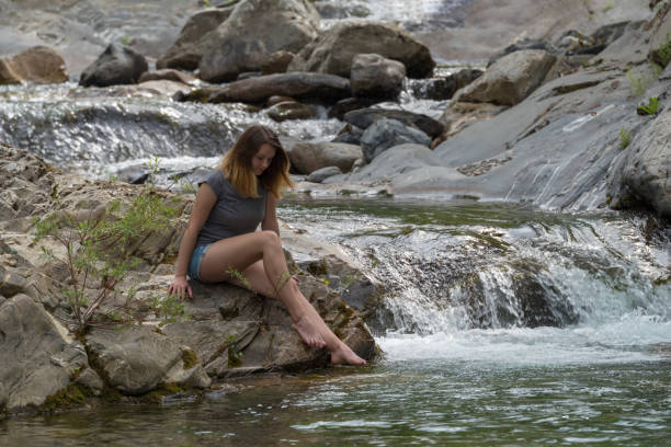 istock Woman by the river 1163329594