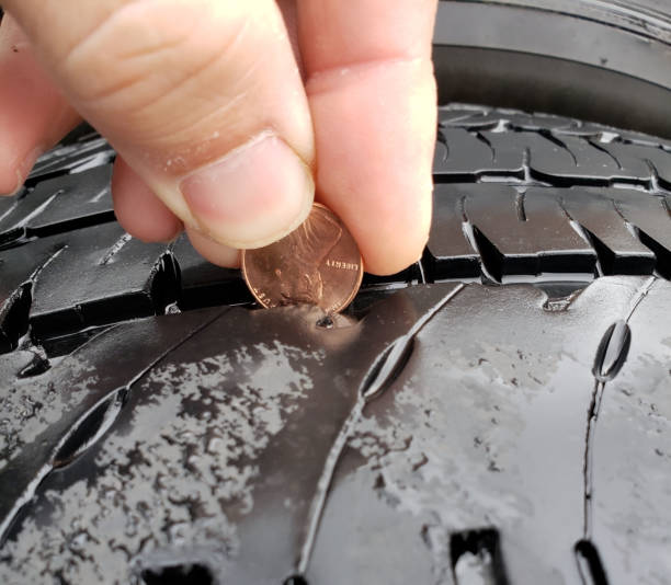 istock Fingers holding penny 1163329610
