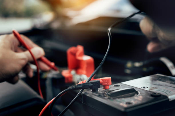 istock Car mechanic is using the car battery meter to measure various values and analyze it. 1163330698