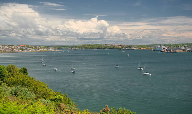A view across Milford Haven to Neyland, the Cleddau Bridge and Pembroke Dock on a summer day with clouds A view across Milford Haven to Neyland, the Cleddau Bridge and Pembroke Dock on a summer day with clouds milford haven stock pictures, royalty-free photos & images
