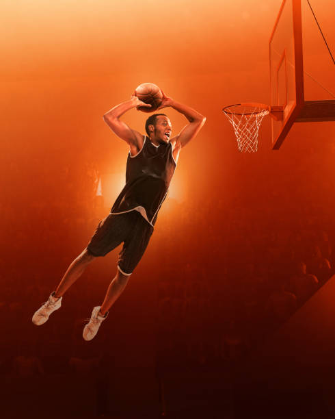 istock Basketball player in action. Red scattered light background 1163332858