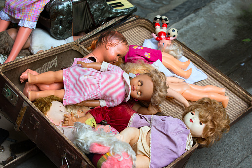 Old dolls. Old dolls in an old suitcase. Retro Dolls
