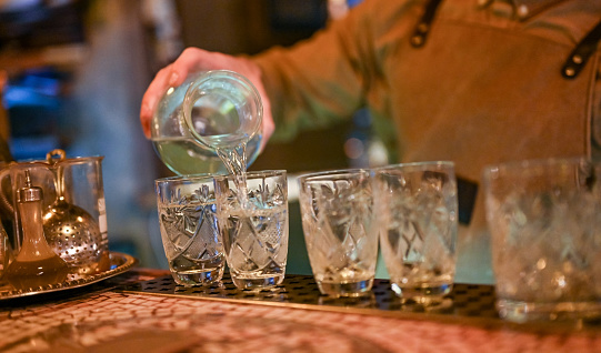 Close-up of unrecognizable bartender pouring vodka
