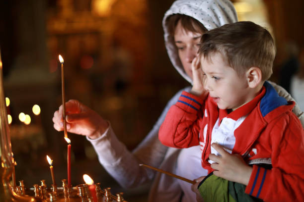 istock Mother and son put candles in Church 1163342021