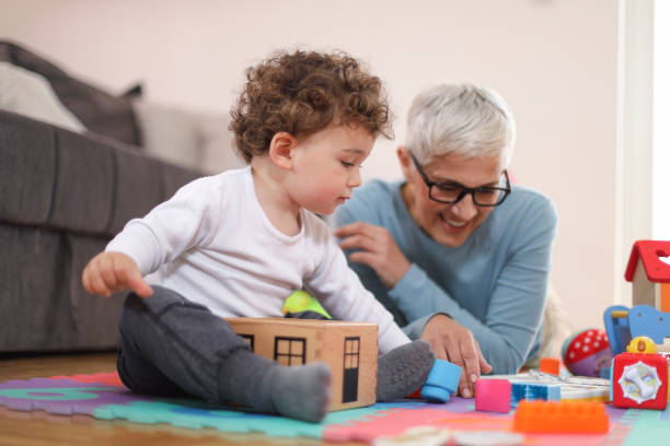 istock Grandmother playing with her grandson 1163343452